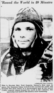 Black and white newspaper photo of cosmonaut Yuri Gagarin in a flight suit. Original headline: Round the world in 89 minutes. Original caption: This is Russian Maj. Yuri Gagarin, history's first man in space. The Russians today rocketed him around the earth and brought him back safely to a prearranged spot in the Soviet Union. Gagarin zipped around the earth in 89.1 minutes. His spaceship was landed 108 minutes after launching.