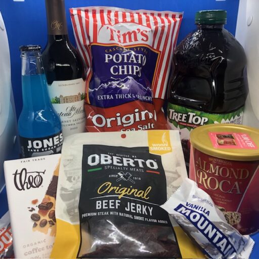 A collection of local products, including Jones Soda, Ste. Chateau Michelle wine, Tim's potato chips, Tree Top apple juice, Theo chocolate, Oberto beef jerky, and Brown & Haley almond rocha and a candy bar.