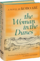 Cover of the 1964 English edition of The Woman in the Dunes, with a drawing of dunes against an orange background.