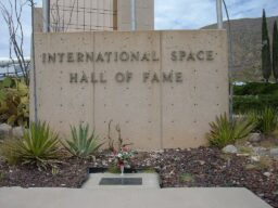 Ham's grave and plaque in front of the International Space Hall of Fame entrance sign.