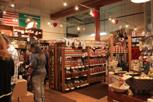 The MarketSpice shop interior, warmly lit, with lots of teas and spices displayed on wooden shelves and in woven baskets.