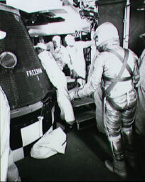 Astronaut Alan Shepard, in his pressure suit and helmet, approaches the Freedom 7 capsule in preparation for insertion before the Mercury-Redstone 3 mission.