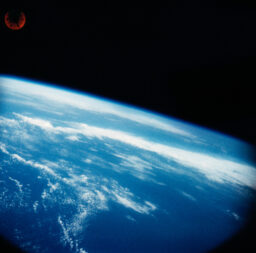 The Earth as seen through the porthole of the Mercury capsule.