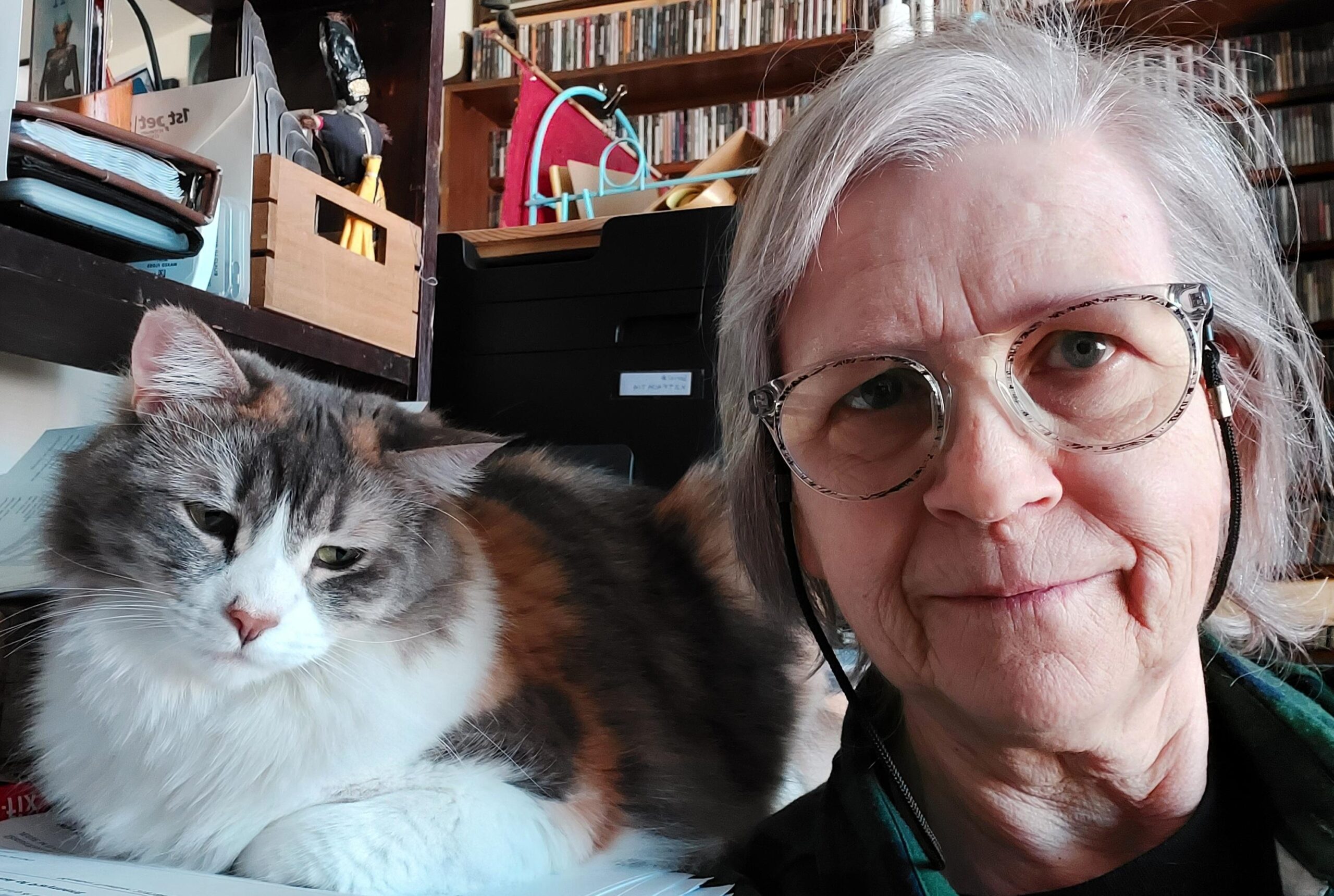 Photo of artist Sarah Clemens with fluffy, fluffy cat.