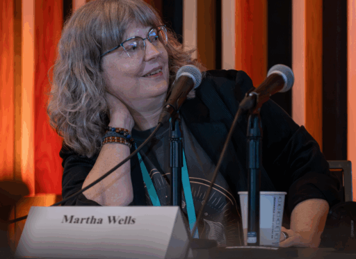 Guest of Honor Martha Wells speaking into a microphone.