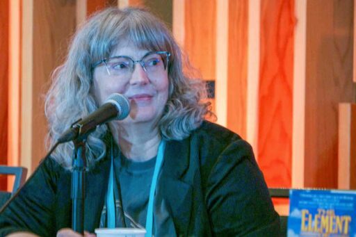Guest of Honor Martha Wells speaking into a microphone.