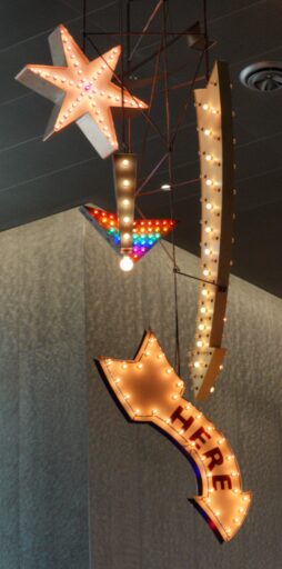 Lighted signs including an arrow with "here" written on it, at the Convention Center